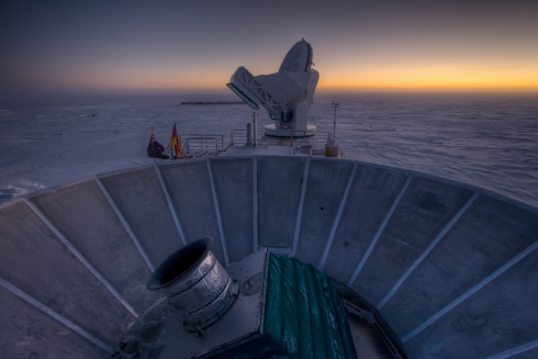 The sun sets behind BICEP2 (in the foreground) and the South Pole Telescope (in the background). (Photo: Steffen Richter, Harvard University via BICEP2 image release gallery)